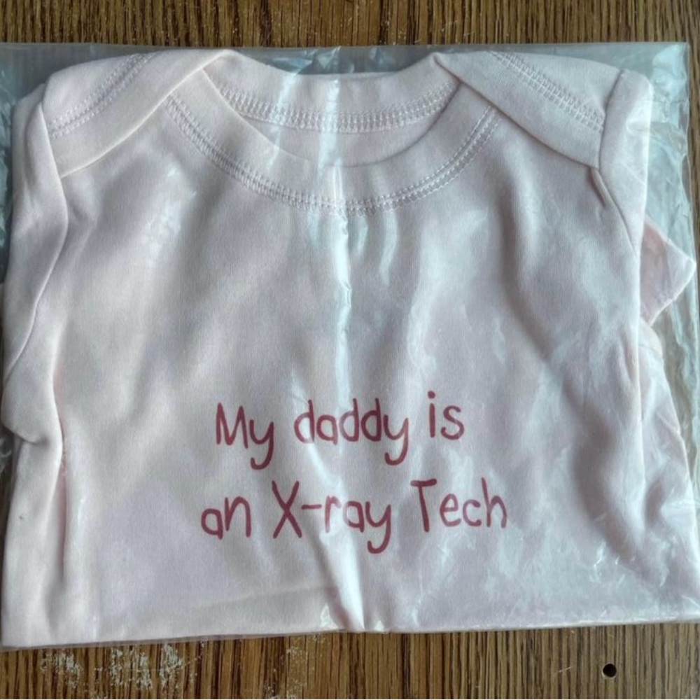 My daddy is an X-ray tech 
Pink onesie 6-12 months